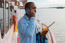 Navy Deck Officer Or First Officer On The Deck Of The Ship Or Boat Talking On A Cell Phone