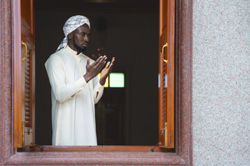 Canvas Print - muslim man having worship and praying for allah blessing in islam ceremony in mosque during islamic ramadan period