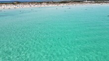 Incredibly Beautiful Beach On The Formentera Island. Many Unrecognizable People Are Relaxing On The Beach On The Island