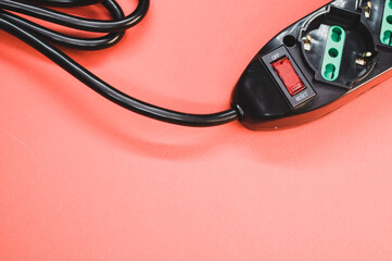 Canvas Print - Closeup shot of an electric extension cord on a pastel background