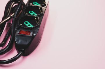 Canvas Print - Closeup shot of an electric extension cord on a pink surface