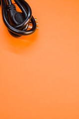 Poster - Black power cable on an orange background