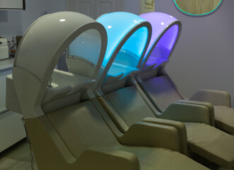 Modern hair washing and massage chairs with multicolor lighting in hairsalon, professional hair salon equipment