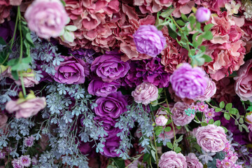 Wall Mural - Closeup image of beautiful flowers wall background with amazing colorful roses. Top view