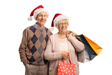 Poster - Elderly couple with shopping bags and santa claus hats