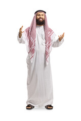 Wall Mural - Full length portrait of a saudi arab man in a traditional thobe smiling and greeting with hands