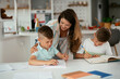 © JustLife - Mother helping her son with homework at home. Little boy learning at home..