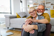 © NDABCREATIVITY - Happy romantic senior couple hugging and enjoying retirement at home