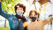 © Mirko Vitali - Happy couple of lovers enjoying autumn travel time outdoor wearing protective mask - New normal love concept with boyfriend and girlfriend having fun together - Bright filter with focus on guy face