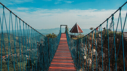 Hanging bridge that connecting two hills of rock at Stone Garden Padalarang, Bandung. Suspension bridge, rope bridge