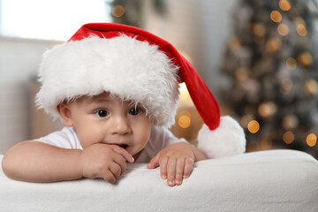 Sticker - Cute little baby wearing Santa hat at home. Christmas celebration