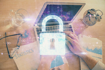 Double exposure of lock icon with man working on computer on background. Concept of network security.