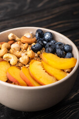 Canvas Print - delicious granola with nuts, peach, blueberry in bowl