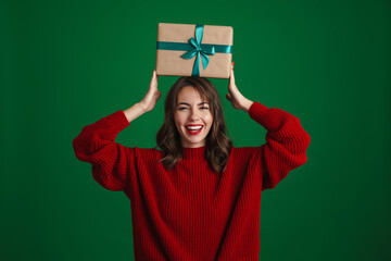 Sticker - Beautiful joyful nice girl holding Christmas gift box on her head