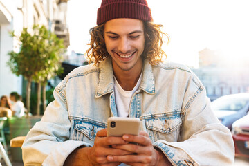 Sticker - Positive young curly man holding credit card