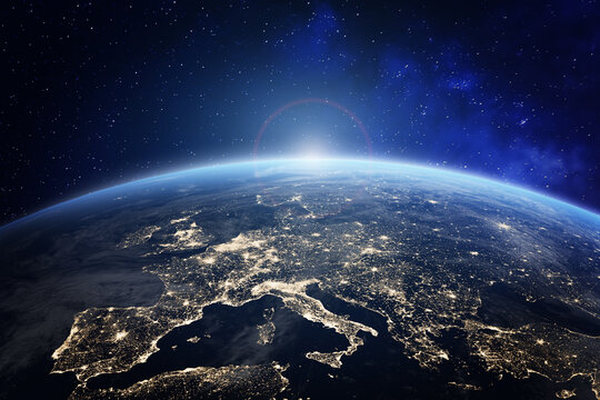 planet earth viewed from space with city lights in europe. world with sunrise. conceptual image for 