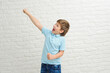 © yana_novak22 - Happy boy making dab arms gesture on white studio background, funny guy dabbing moving in internet meme pose celebrating victory having fun, dance school or triumph concept