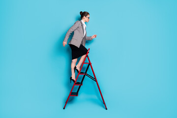 Canvas Print - Full body profile side photo of ambitious lady climb ladder career wear blazer skirt isolated blue color background