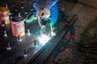 A welder is using a Stud Welding Machine to weld stud bolt on steel plate, at industrial factory.