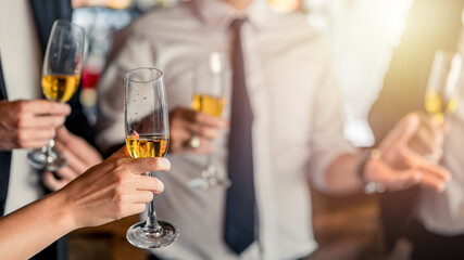 Group of business people holding champagne glasses during a party. Successul business celebration.	
