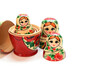 Several heads from nesting dolls lined up in a semicircle and one assembled nesting doll