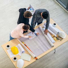 Top view of Caucasian engineer group teamwork meeting for planning project on the table with paperwork.