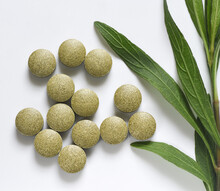Green Herb Tablet With Green Branch On White Background