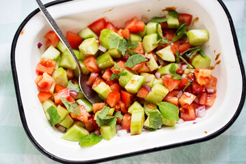 Wall Mural - Tomato, cucumber, red onion salad with mint and balsamic vinegar