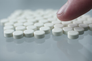 Wall Mural - White pills on glass table