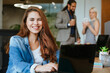 © lithiumphoto - Portrait of business woman working in the office using laptop