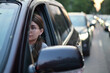 © Вячеслав Думчев - A young woman sits in a car during rush hour