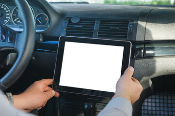 Mock up tablet in car salon. against the background of the dashboard.