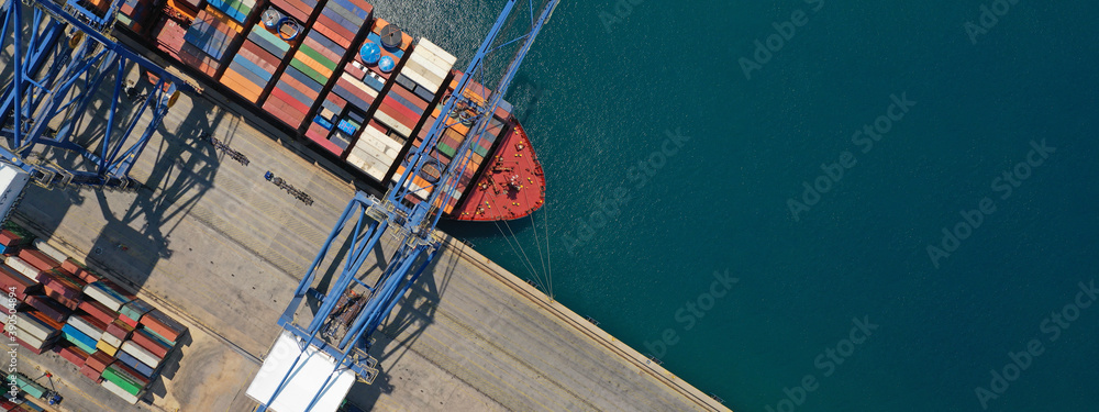 Aerial top down ultra wide photo of industrial cargo container ship loading in logistics terminal port - obrazy, fototapety, plakaty 