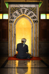 Wall Mural - muslim man having worship and praying in islam ceremony in mosque