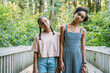 © Inti St. Clair - Portrait of serious teen sisters standing in nature park