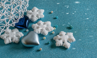 Wall Mural - Christmas aqua blue background with blue and silver bauble hearts, snowflakes, beads and decorative wet.