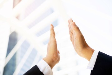 A close-up picture of a businessman shaking hands on a business cooperation agreement in the heart of the city. Concept of Cooperation  business and success