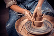 Potter craftsman demonstrates the process of making ceramic dishes using the old technology. Inspiration and creativity. Close-up.