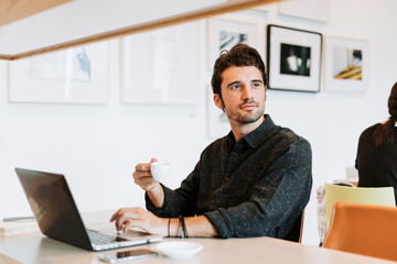 Canvas Print - Man drinking coffee while working