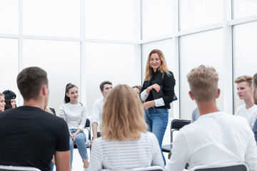 Wall Mural - young woman standing in a circle of her colleagues.