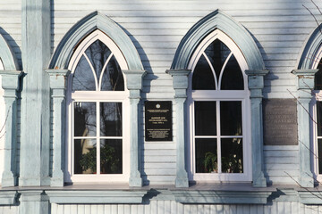 Ornamental windows. Gothic style in wooden architecture. Prushakevich's house (1895) with carved windowds and gate in Ulyanovsk city, Russia. Ulyanovsk landmark, Ulyanovsk monument