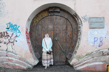 Wall Mural - Girl in russian style, round wooden door of 