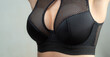 Black bra. Sexy young womans boobs in black lingerie bra. Push up effect lingerie. Correcting lingerie for woman. Beautiful fit woman wearing black bra at her sexy big boobs.