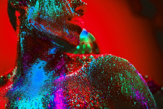 people are colored fluorescent powder. a pair of lovers dancing at a disco.