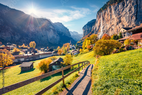 First sunlight glowing Lauterbrunnen village valley. Impressive outdoor scene in Swiss Alps, Bernese Oberland in the canton of Bern, Switzerland. Traveling concept background..