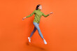 © deagreez - Full body profile side photo of young excited girl run hurry jump sale look empty space isolated over orange color background