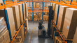 © Gorodenkoff - High Angle Shot: Electric Forklift Truck Operator Lifts Pallet with Cardboard Box of in a Big Retail Warehouse a Shelf. Logistics Product and Goods Delivery and Distribution Center