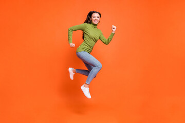 Poster - Full size profile sid photo of young active crazy girl have fun enjoy run jump happy smile isolated over orange color background