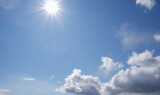 Fototapeta  - Blue sky with clouds and sun.