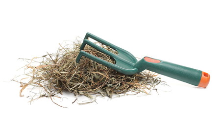 Wall Mural - Rake and hay pile, dry grass isolated on white background